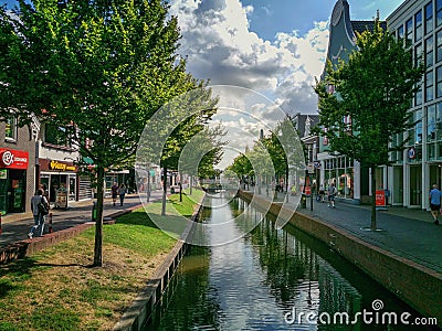 Trees grow along the canal in Zaandam Editorial Stock Photo