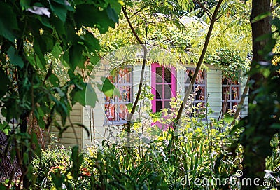 Garden shed surrounded by a beautiful decorative garden Editorial Stock Photo