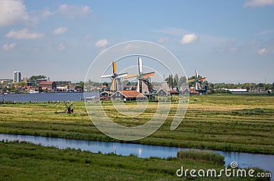 Old dutch windmills and river in historical village. Holland mills in field panoramic view. Rural holland landscape. Editorial Stock Photo