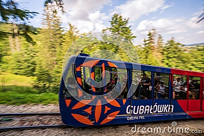 Zakopane, Poland: Pan shot of Funicular railway at Gubalowka with motion blurred , Passengers or tourist Editorial Stock Photo