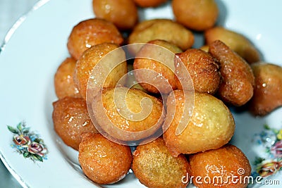 Zalabia on a white plate, a type of middle eastern fried dough similar to that of a doughnut, a tasty dessert Stock Photo