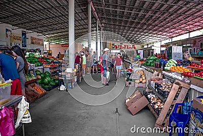 Big hall of the farmers market in Zaliznyi Port Kherson region. Buyers and sellers near Editorial Stock Photo