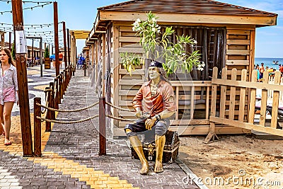 Statue of a pirate with a treasure chest on the embankment in Zalizny port Kherson region Editorial Stock Photo