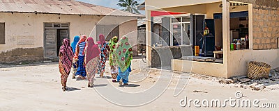Panorama of a group of covert moslem women, backview at the street in the fishing village of Nungwi. Editorial Stock Photo