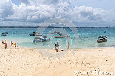 Tourists wait for boats on Prison Island (Changuu Island) to return to Zanzibar mainland Editorial Stock Photo