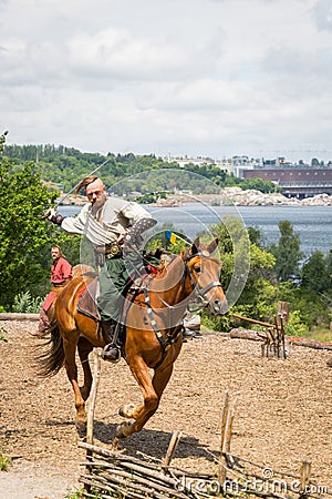 ZAPORIZHIA, UKRAINE-JUNE 21: Ukrainian Cossacks 21, 2014 in Zaporizhia, Ukraine. Show of Ukrainian Cossacks in Cossacks Museum on Editorial Stock Photo