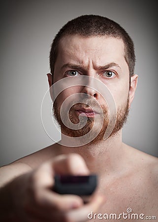 Zapping - annoyed man with tv remote control Stock Photo