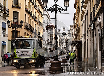 Cleaning worker cleans and disinfects the pedestrian streets in the center of Zaragoza. Editorial Stock Photo