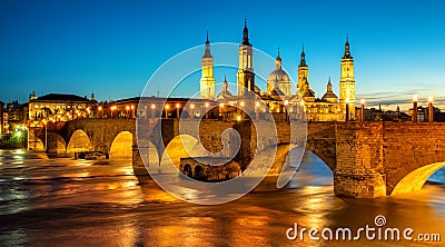 Zaragoza city, Spain, bridge and Cathedral del Pilar at sunset Stock Photo