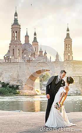 wedding photographer and videographer taking photo and video of bride and groom in city near Ebro Editorial Stock Photo