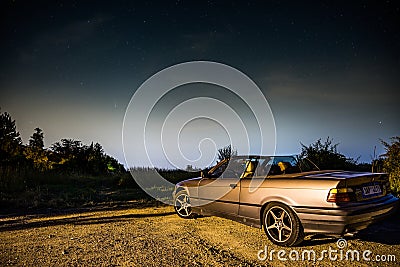 Zdimerice, Czech republic - July 22, 2020. Old convertible car parked above the city watching the night sky with comet C/2020 F3 N Editorial Stock Photo