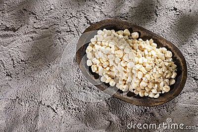 Zea mays - White threshed corn in the wooden bowl Stock Photo