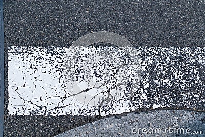 Zebra crossway with some faded on asphalt road close-up view Stock Photo