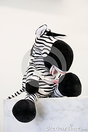 zebra soft toy for showing demonstration of proper brushing of teeth hands of toy toothbrush in mouth false teeth on Stock Photo