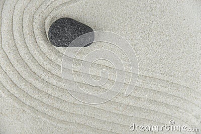 Zen garden. Pyramids of white and gray zen stones on the white sand with abstract wave drawings. Stock Photo