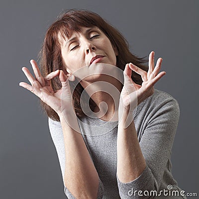 Zen relaxation for meditating 50s gorgeous woman Stock Photo