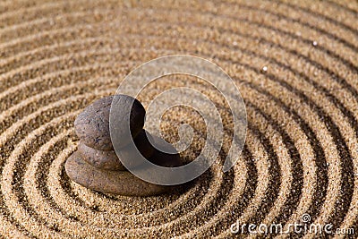 Zen stacked stones on sand in natural light Stock Photo