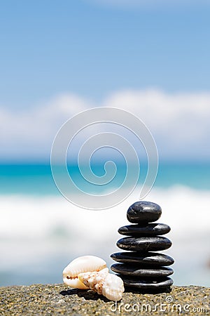 Zen stones jy on the sandy beach near the sea. Stock Photo