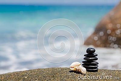 Zen stones jy on the sandy beach near the sea. Stock Photo