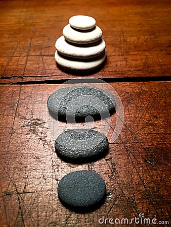 Zen stones on a weathered antique table. Stock Photo