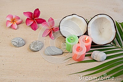 Zen tropical background with coconuts, plumeria flowers, rocks, and burning candles Stock Photo
