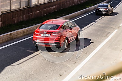 Zenith view of BMW X4 car driving on highway road. Rear view of red SUV crossover in motion Editorial Stock Photo