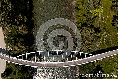 Zenith view of a modern arch shaped design pedestrian bridge over the Ticino river in Switzerland Editorial Stock Photo