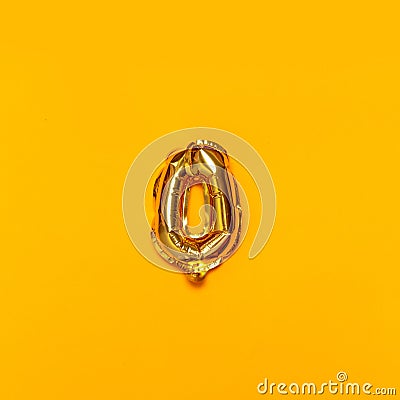 Zero number gold air balloon on a yellow background Stock Photo