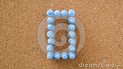 Zero, number made by pastel blue pushpin on cork board texture Stock Photo