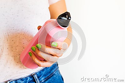 Woman holding reusable water bottle Stock Photo