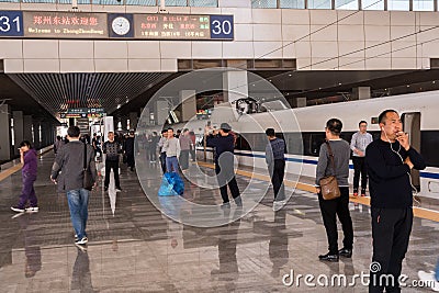 Smokers by high speed train at platform in China Editorial Stock Photo