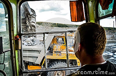 Zhodzina, Belarus - August 16, 2013: Granite mining in Quarry Trucks quarry of BelAZ producer Editorial Stock Photo