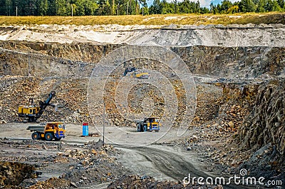 Zhodzina, Belarus - August 16, 2013: Granite mining in Quarry Trucks quarry of BelAZ producer Stock Photo