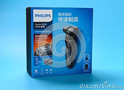 Box of brand new electric shaver on a blue background Editorial Stock Photo