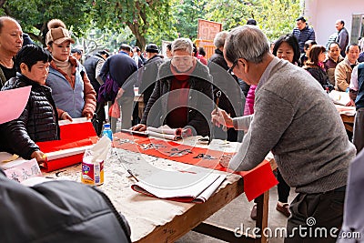 People writing Chinese new year scrolls Editorial Stock Photo