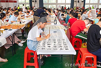 students in calligraphy competition using Chinese brushes at horizontal composition Editorial Stock Photo