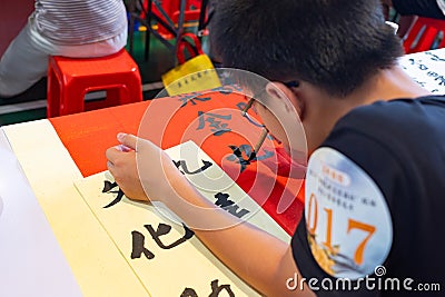 students in calligraphy competition using Chinese brushes at horizontal composition Editorial Stock Photo