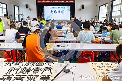 students in calligraphy competition using Chinese brushes at horizontal composition Editorial Stock Photo