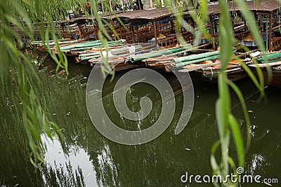 ZHOUZHUANG, CHINA: Helmsman driving the boat passing through canals Stock Photo