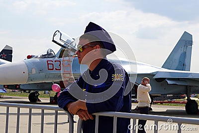 ZHUKOVSKY, RUSSIA, JUL. 2015: Aerospace aircraft exhibition MAKS 2015. Aircraft pilot in navy uniform and brown sun glasses at jet Editorial Stock Photo