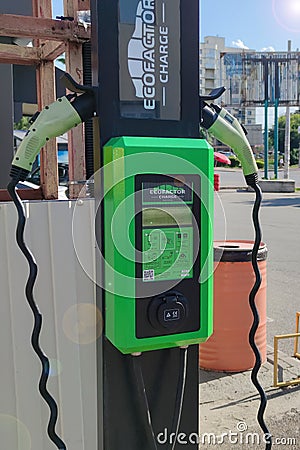 Power supply for charging an electric car. Convenience of electric charging, replenishing the Editorial Stock Photo
