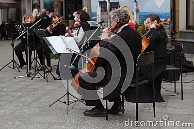 Zhytomyr, Ukraine - May 15, 2021: man street musician playing cello classical music Editorial Stock Photo