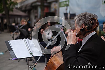 Zhytomyr, Ukraine - May 15, 2021: man street musician playing cello classical music Editorial Stock Photo