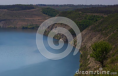 Zigzag river flows between summer valleys. Dniester river Stock Photo