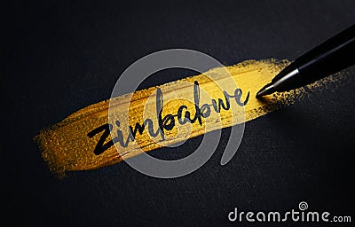 Zimbabwe Handwriting Text on Golden Paint Brush Stroke Stock Photo