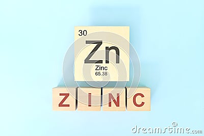 Zinc chemical element symbol with atomic mass and atomic number in wooden blocks flat lay composition. Stock Photo