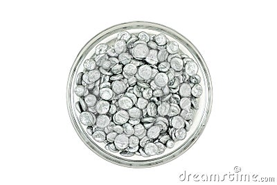 Zinc granules in a glass dish Stock Photo