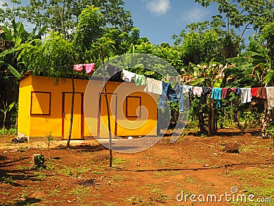 Zinc sheet metal house in jungle with laundry drying Quinn Hill Stock Photo