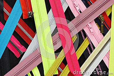 Zip background texture of zippers sliders. a lot of zippers in different colors. sewing clothes, atelier, fabric and accessories s Stock Photo