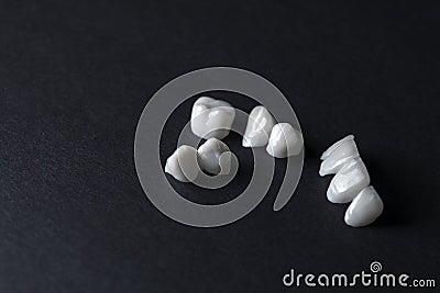 Zircon dentures on a black background - Ceramic veneers - lumineers Stock Photo